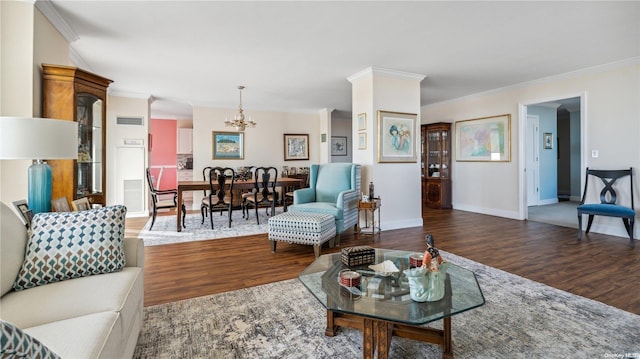 living room with a chandelier, dark hardwood / wood-style floors, and crown molding