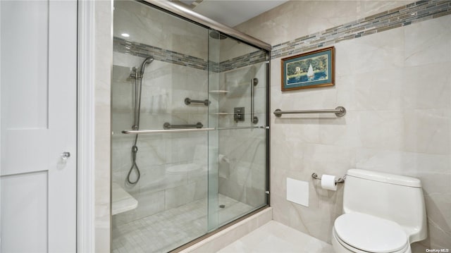 bathroom featuring toilet, tile walls, and walk in shower