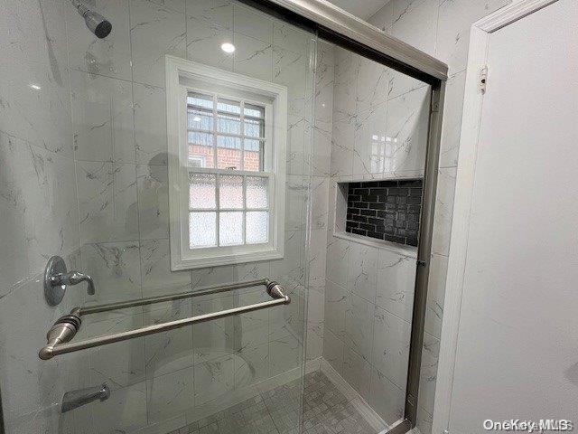 bathroom with a shower with shower door