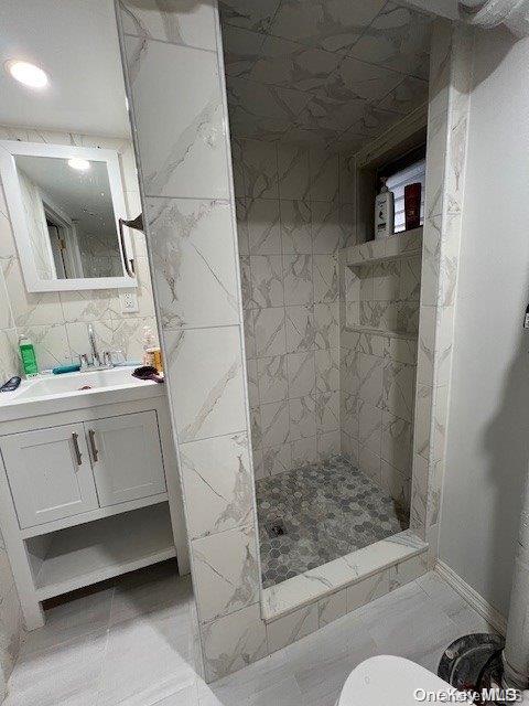 bathroom with vanity, toilet, and walk in shower