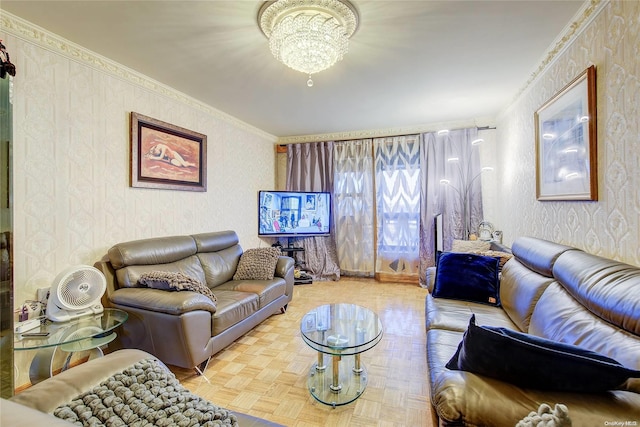 living room featuring ornamental molding, a notable chandelier, and parquet flooring