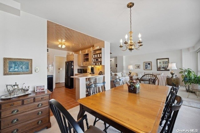 dining area featuring a notable chandelier and light tile patterned floors