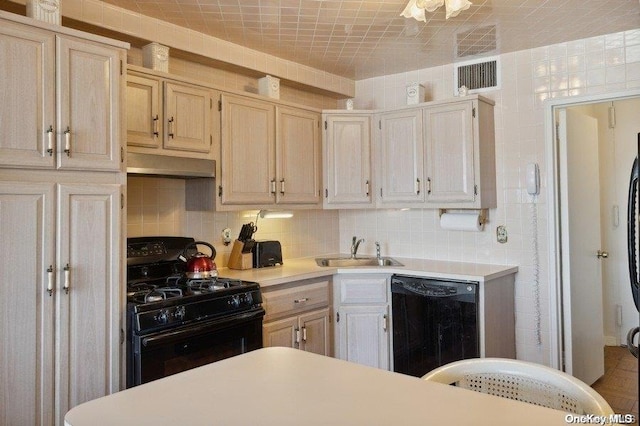 kitchen featuring black appliances, decorative backsplash, sink, and light brown cabinetry