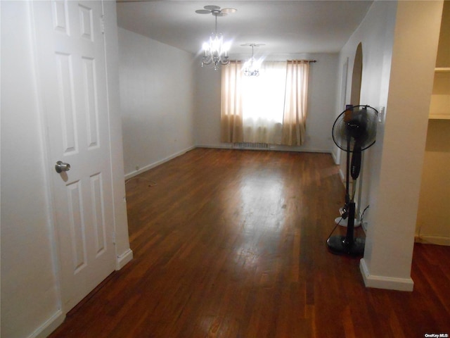 interior space featuring a notable chandelier and dark hardwood / wood-style floors