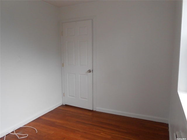 empty room featuring dark hardwood / wood-style flooring