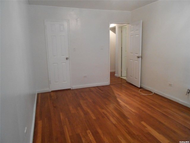 unfurnished room featuring dark hardwood / wood-style flooring