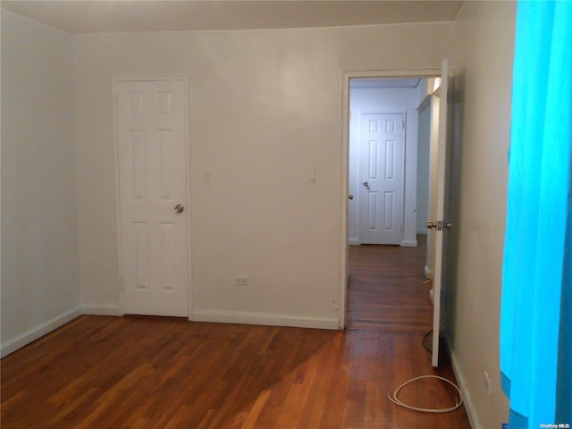 spare room with dark hardwood / wood-style flooring