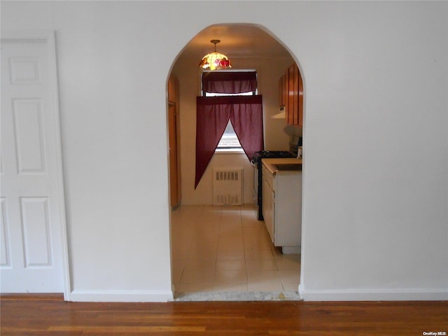 hallway featuring light wood-type flooring and radiator