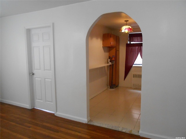 corridor featuring dark hardwood / wood-style floors and radiator