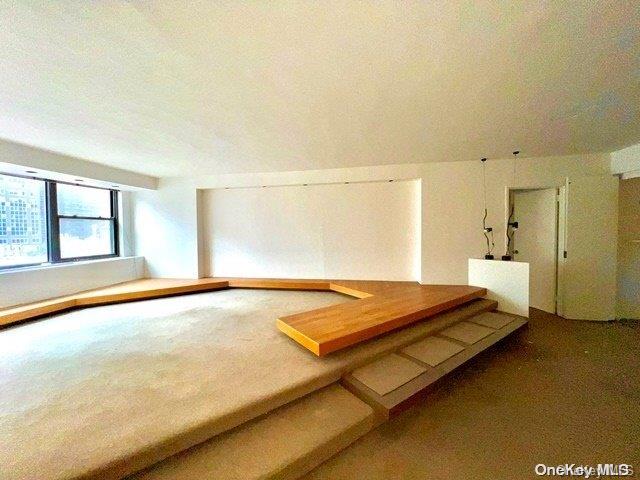 bonus room with carpet floors and a textured ceiling