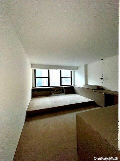 unfurnished living room with carpet flooring and a textured ceiling