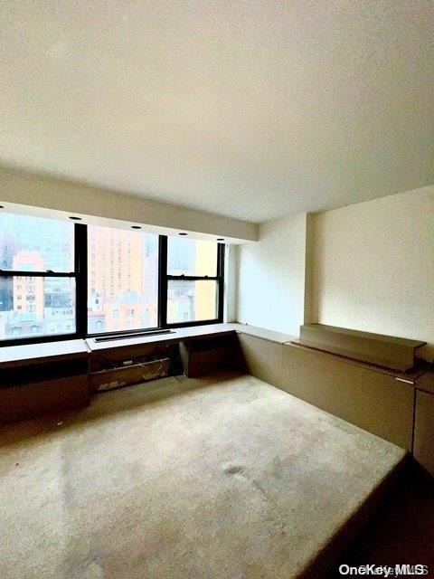 carpeted empty room with a textured ceiling