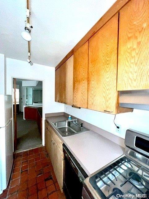 kitchen featuring range, black dishwasher, and sink