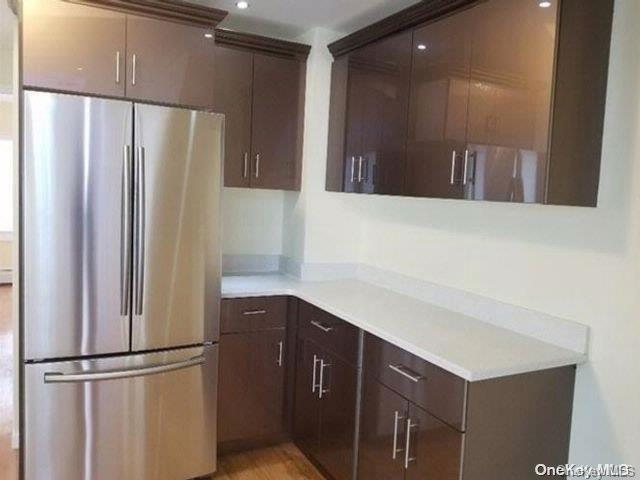 110-16 160th St, Jamaica, NY 11433 - kitchen featuring freestanding refrigerator, light countertops, dark brown cabinets, and recessed lighting