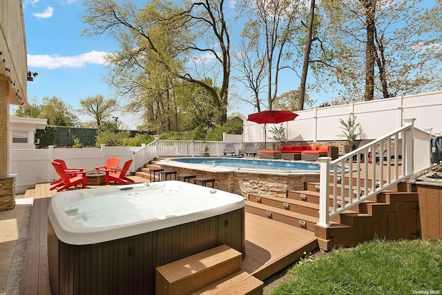 exterior space featuring a hot tub and a deck