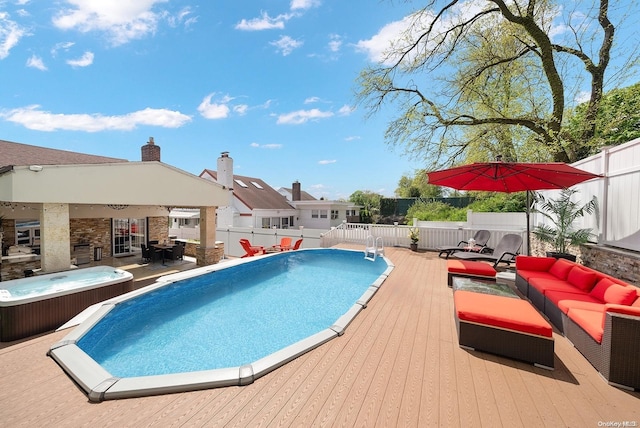 view of swimming pool featuring a wooden deck and an outdoor living space