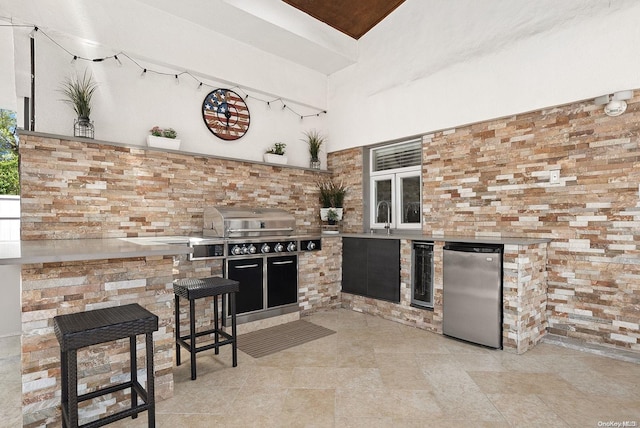 view of patio with sink, area for grilling, beverage cooler, and exterior kitchen