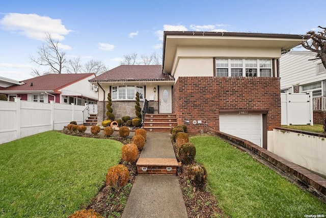 view of front of home with a front yard and a garage