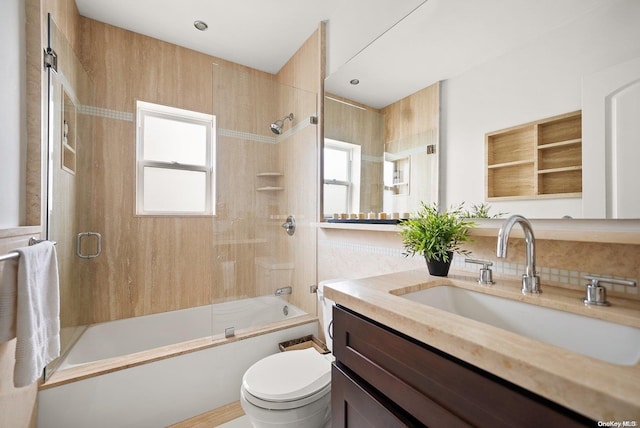 full bathroom featuring shower / bath combination with glass door, vanity, and toilet