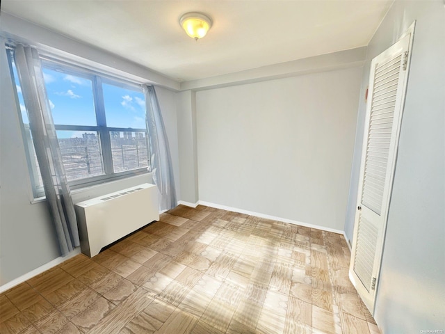 unfurnished bedroom with light wood-type flooring and radiator