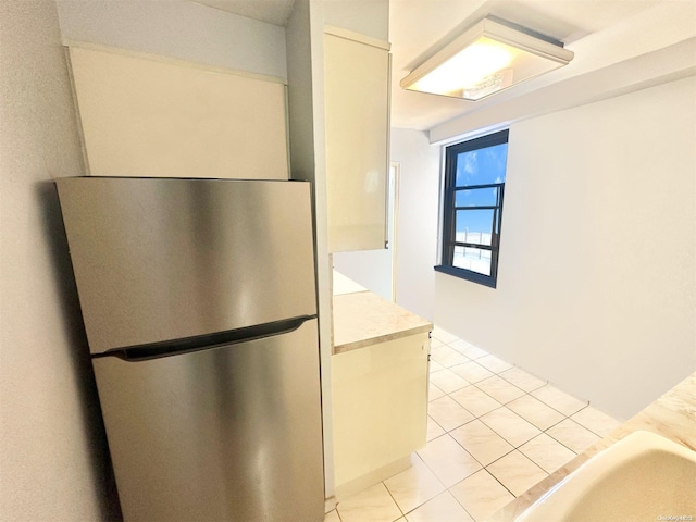 kitchen featuring stainless steel fridge and light tile patterned floors