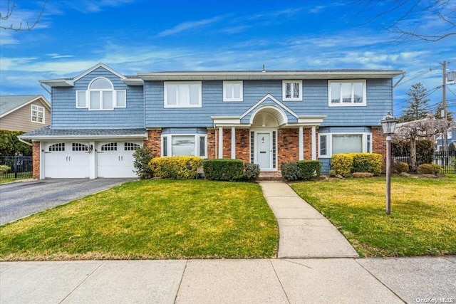 4 Midfarm Rd, Rockville Centre, NY 11570 - townhome / multi-family property featuring brick siding, asphalt driveway, and a garage