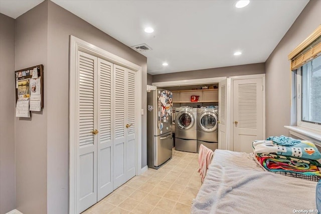 washroom with washing machine and clothes dryer