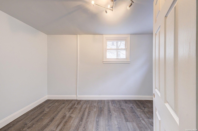 empty room with dark hardwood / wood-style flooring