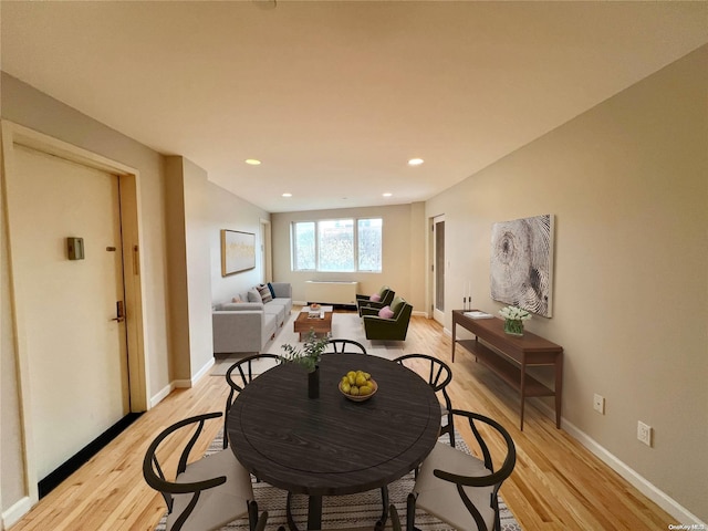 dining space with light hardwood / wood-style floors