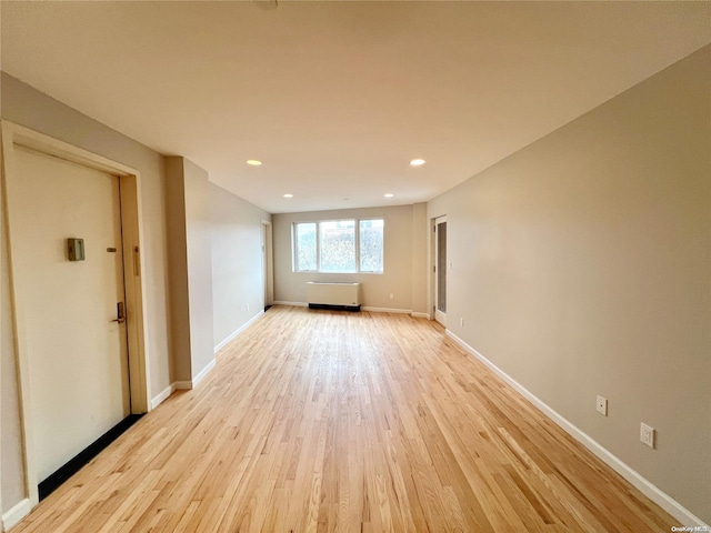 spare room with light hardwood / wood-style flooring