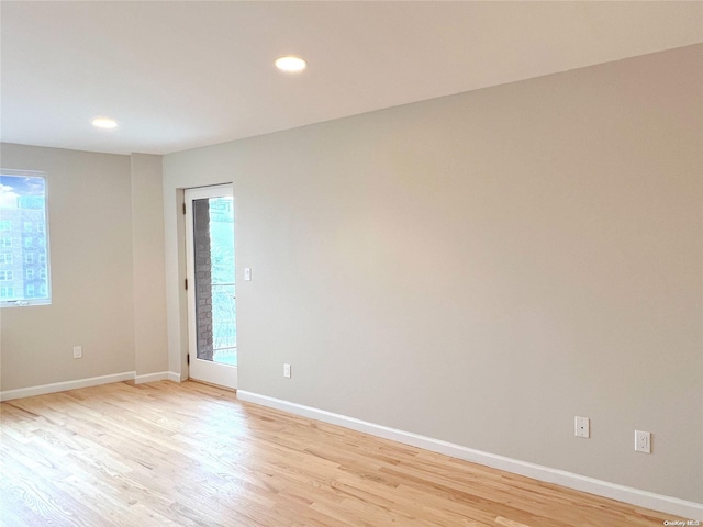 spare room featuring light hardwood / wood-style flooring