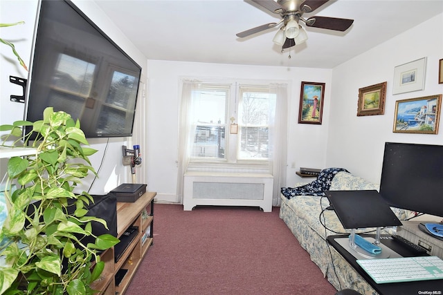 interior space featuring ceiling fan, dark carpet, and radiator