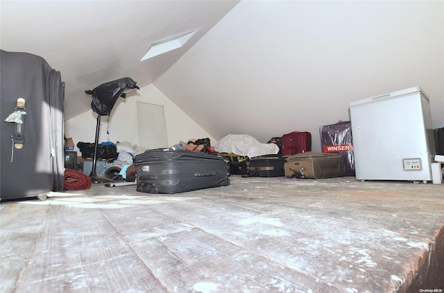 additional living space featuring lofted ceiling with skylight