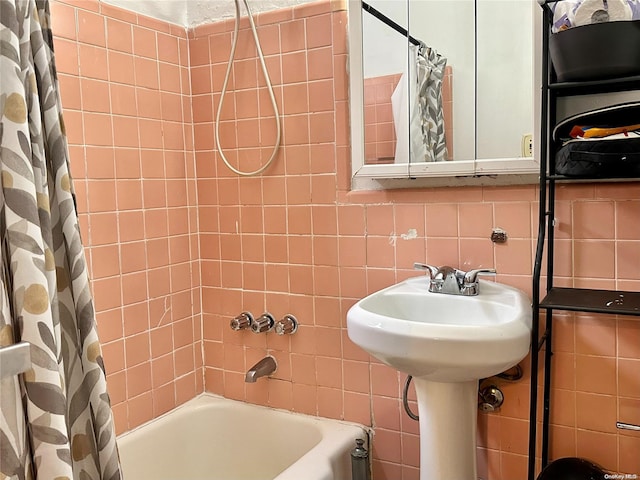 bathroom with backsplash, tile walls, and shower / bath combo with shower curtain