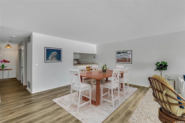 dining area with hardwood / wood-style floors