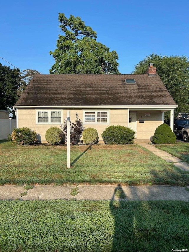 31 William St, Copiague, NY 11726 - view of front of property featuring a chimney and a front lawn