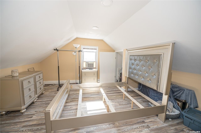 bedroom featuring lofted ceiling and hardwood / wood-style flooring