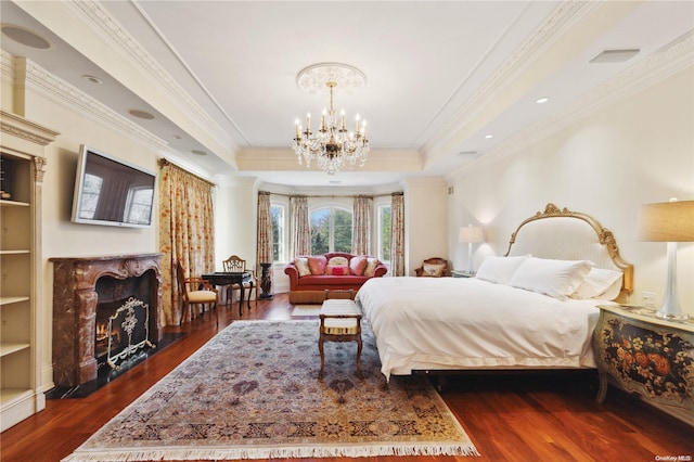 bedroom with a chandelier, crown molding, a fireplace, and dark wood-type flooring