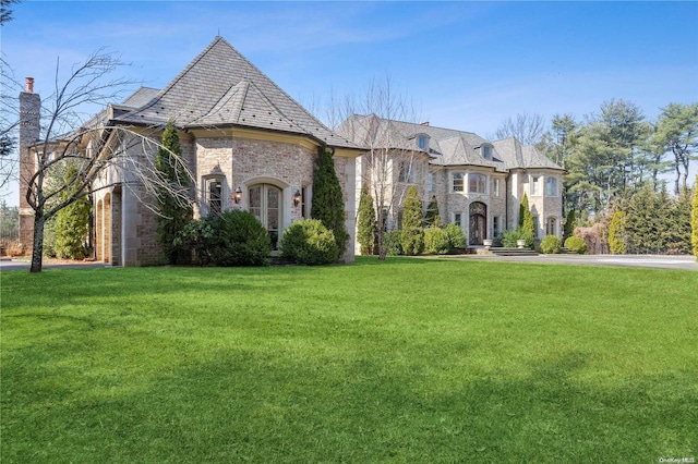 french country home with a front lawn