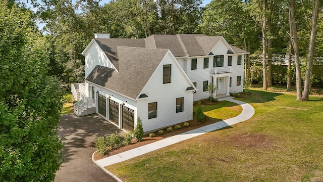 view of front of house featuring a garage and a front yard