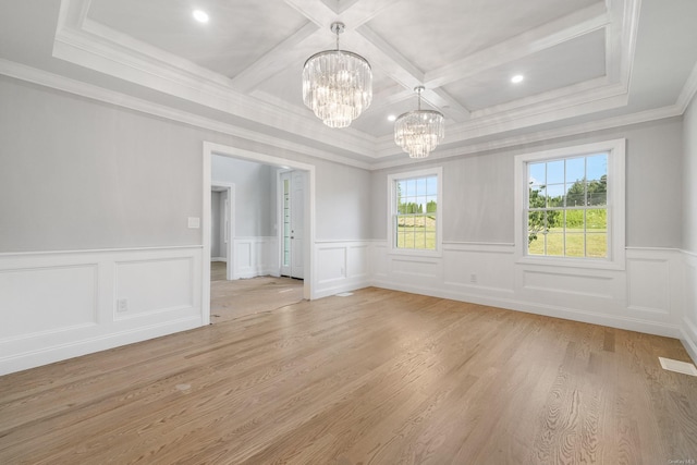 unfurnished room featuring coffered ceiling, light wood-type flooring, ornamental molding, a notable chandelier, and beamed ceiling