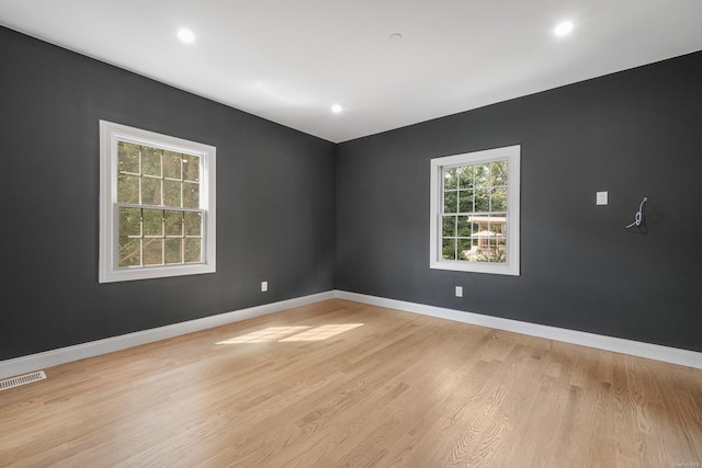 spare room featuring light hardwood / wood-style floors