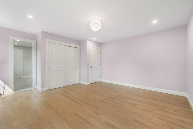 unfurnished bedroom featuring a closet and light hardwood / wood-style flooring