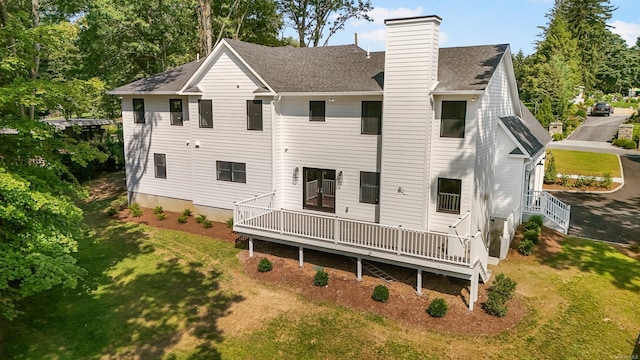 rear view of property with a lawn