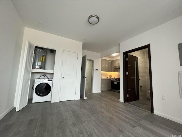 laundry area with washer / clothes dryer, water heater, and dark wood-type flooring