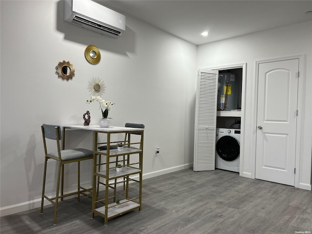 dining space featuring washer / clothes dryer, water heater, a wall mounted AC, and dark hardwood / wood-style floors