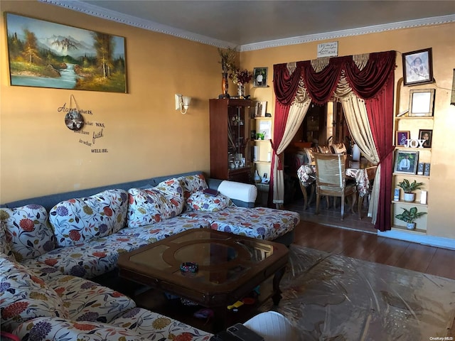 living room featuring wood-type flooring and ornamental molding