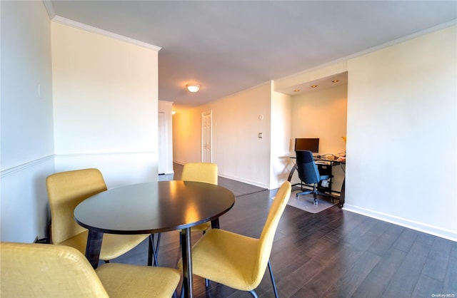 dining room featuring dark hardwood / wood-style floors and ornamental molding