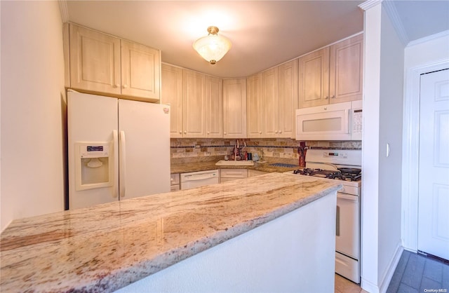 kitchen with decorative backsplash, light stone countertops, white appliances, and ornamental molding