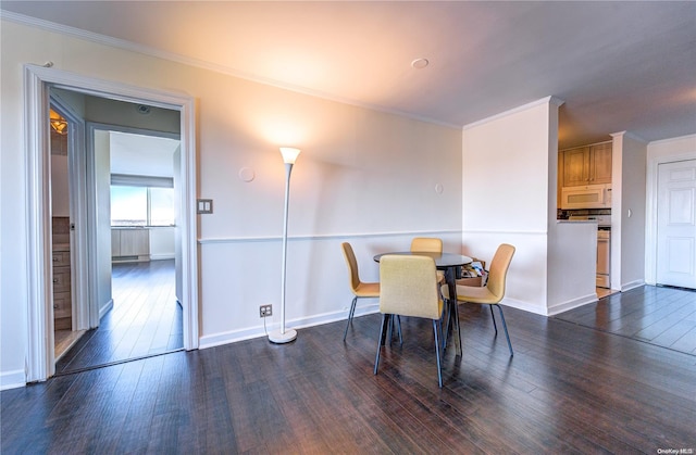 dining room featuring dark wood-type flooring and ornamental molding